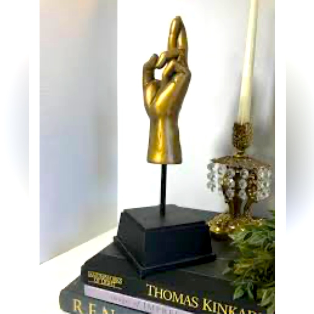 Vintage gold crossed finger statue with black museum base. Great for an office!